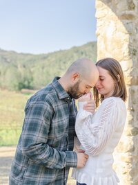 Man kissing his girlfriend’s hand during a romantic engagement photo session in Pasadena.