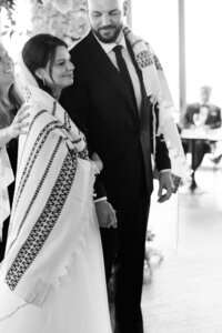 Bride wears a talit during Jewish ceremony