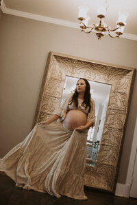 Expectant Mother in front of gold floor length mirror at Maison Charlottesville. Photography by Amy Mitchell.