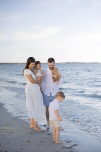 A coastal New England family session with toes in the sand and salty snuggles by the water's edge. North Shore Family Photographer. Deborah Zoe Photography.