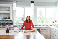 Branding portrait of a Bend Oregon entrepreneur standing in a bright modern kitchen