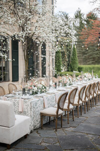 Wedding reception decor with long table, florals, and chairs in wedding photography Detroit MI