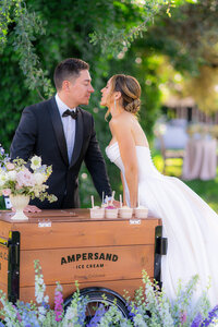 Bride and groom garden wedding ice cream cart kiss at rainbow oaks ranch in sanger california.