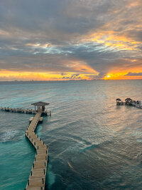 View of the pier and sunset from Impressions Isla Mujeres in Mexico, with impressive view of the ocean