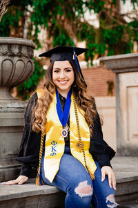 MTSU senior wearing Phi Kappa Phi stole, cords, and medal