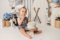 Baby celebrates his first birthday with a Cake Smash Portrait Session at Holy City Babies Portrait Studio in Charleston, SC.