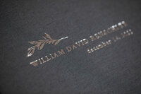 Silver foil debossed title on grey-blue linen cover of baby album book