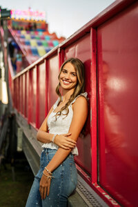 Senior portrait at the Greater Gulf State Fair in Mobile, Alabama — leaning against the slide
ride.