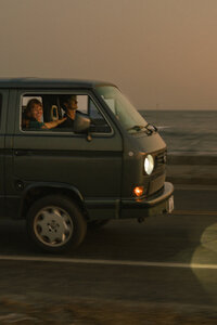 Couple driving along Ocean Drive in Newport, RI