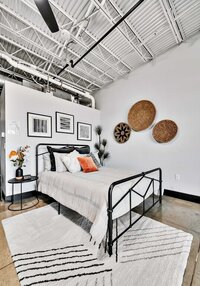 Bedroom area with industrial modern vibes in this studio vacation rental condo in the historic Behrens building with a 5th floor view of downtown Waco, TX