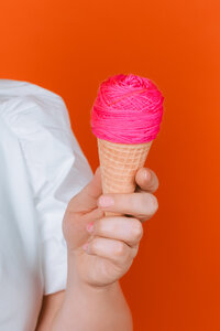 Voice over artist photographed with a bright orange prop during a colorful personal branding session.