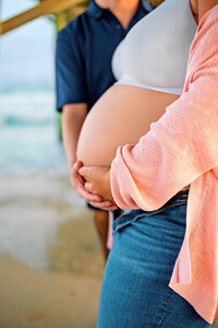 Close up of expectant mother holding her belly during an Atlantic Beach maternity session