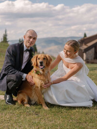 Bride and groom pose with their Golden Retriever at their luxury black-tie mountain wedding in Beaver Creek, Colorado.