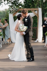 wedding couple kissing after getting married at ivy hall in roswell