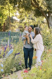 Parents looking at baby adoringly during their family photo shoot at Gamble Gardens