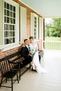 Best historic Louisville Kentucky wedding venue with couple seated on the Locust Grove porch