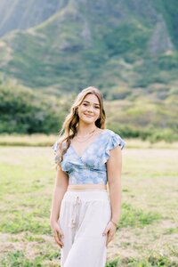 girl with a blue top and white pants