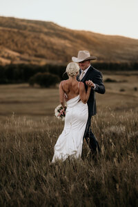 Wedding and Elopement Photography, Bride and groom embrace during sunset mountain micro wedding photos.