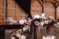 boho tent with greenery garland and pampas arrangements on sides