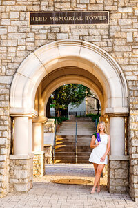 College senior leaning against the Reed Memorial bell tower at Trevecca University