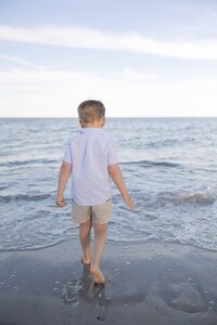 A coastal New England family session with toes in the sand and salty snuggles by the water's edge. North Shore Family Photographer. Deborah Zoe Photography.