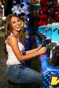 Senior portrait at the Greater Gulf State Fair in Mobile, Alabama — laughing while playing the
water gun game.