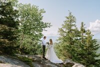 Couple Reading Private Vows on a mountain in the High Peaks of the Adirondacks while dressed in Wedding Attire