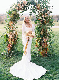 Bride under floral arbor