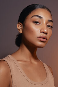 Tajah Moore in a close-up beauty portrait with glowing skin and delicate makeup, photographed by Ylva Erevall.