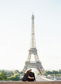 Couple embraces in front of Eiffel Tower