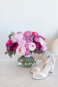 These bridal shoes are accompanied by a beautiful bouquet.