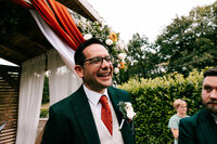 candid wedding photography at Bickley mill captures grooms first look at bride smiling candidly