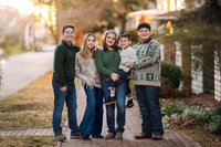 Family standing together at sunset during a golden hour family session in New Bern NC