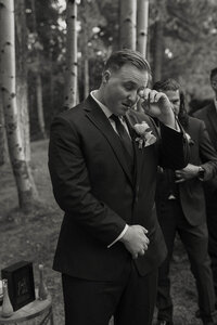 groom wiping a tear at his ceremony in lake tahoe