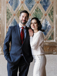 Sophisticated editorial wedding portrait of a couple in Central Park, NYC, featuring classic architecture and city style.