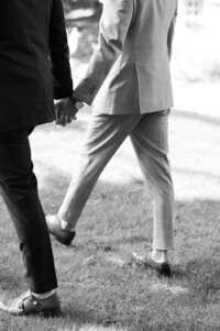 Hands and feet of the grooms as they walk down the aisle