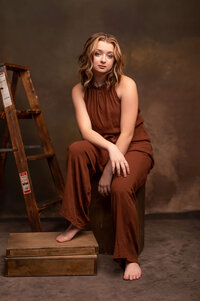 A theater student from New Berlin West High School has her portrait taken backstage in a monochromatic set.