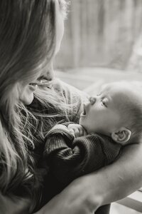 A mom smiles at her infant son
