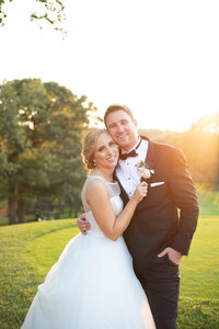 Wedding couple smile with heads together overlooking scenic sunset at Blackhawk Country Club in Madison WI