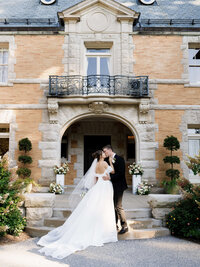 A refined composition of a bride and groom in front Cairnwood Estate, capturing an intentional presence for a documentary style gallery.