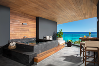 Elegant oceanfront suite with a private jacuzzi and modern decor, offering the ultimate luxury all-inclusive resort experience.