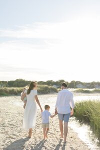 A coastal New England family session with toes in the sand and salty snuggles by the water's edge. North Shore Family Photographer. Deborah Zoe Photography.