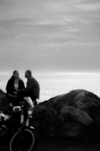 couple embracing on rocks motorcycle engagement photos on pacifica beach
