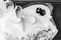 Husband and wife wedding photographer capture brides shoes and jewelry before ceremony in Tennessee