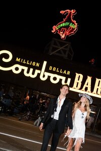 Bride and groom celebrating outside the Million Dollar Cowboy Bar in Jackson Hole, Wyoming after their wedding
