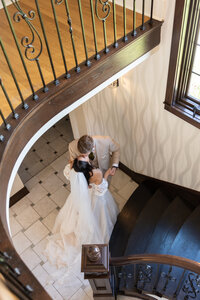 Bride and groom at bottom of stairwell during wedding photography at Venue3Two in Grand Rapids Michigan