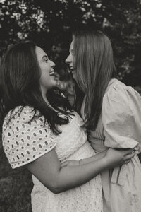 Photo of two women laughing together during their couples photoshoot in bloomington indiana,
