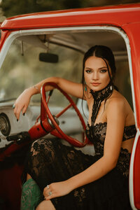 Senior portrait at Triple T Farms in Fruitdale, Alabama — sitting in the driver’s seat with the door
open, arm on the steering wheel.