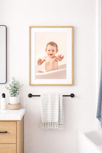 portrait of baby at bath time handing in bathroom of new bern home