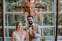 Wedding officiant smiling with newlyweds
